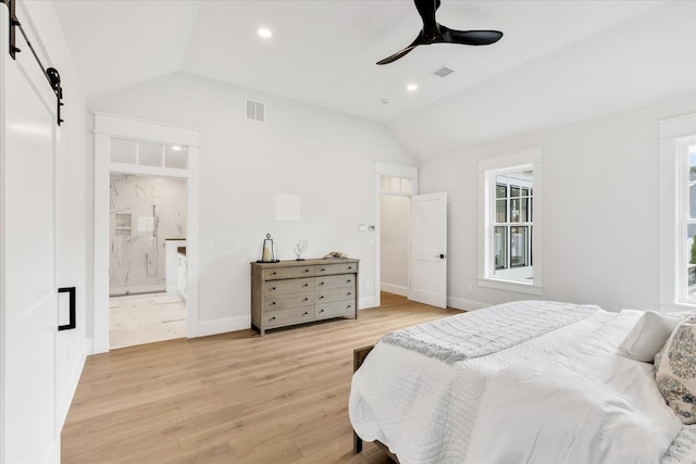 22 Country Club Ln, Mashpee, MA 02649 - bedroom with lofted ceiling, multiple windows, light wood-type flooring, and a barn door