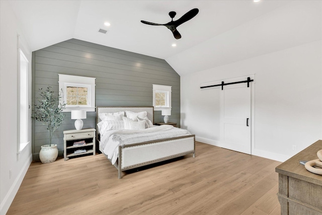 22 Country Club Ln, Mashpee, MA 02649 - bedroom featuring a barn door, vaulted ceiling, light wood-style floors, baseboards, and visible vents