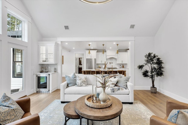22 Country Club Ln, Mashpee, MA 02649 - living area with light wood-style flooring, visible vents, and beverage cooler