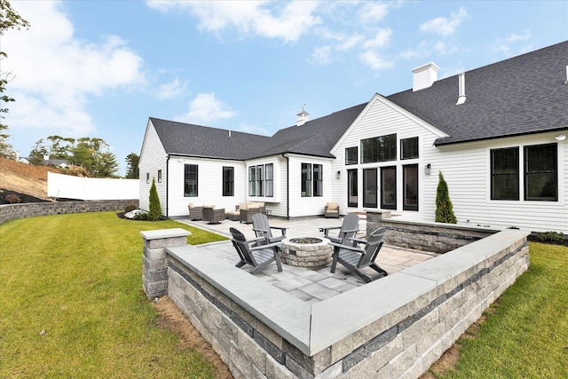 22 Country Club Ln, Mashpee, MA 02649 - rear view of property featuring fence, a yard, an outdoor living space with a fire pit, a patio, and roof with shingles
