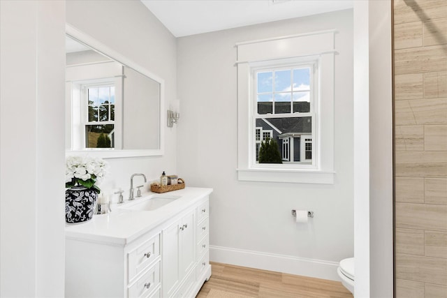 22 Country Club Ln, Mashpee, MA 02649 - bathroom featuring baseboards, toilet, vanity, and wood finished floors