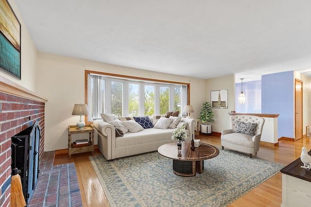 88 Hilltop St, Milton, MA 02186 - living area with a brick fireplace, wood finished floors, and baseboards