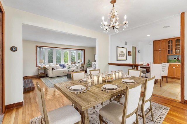 88 Hilltop St, Milton, MA 02186 - dining room featuring light wood finished floors, baseboards, and a chandelier