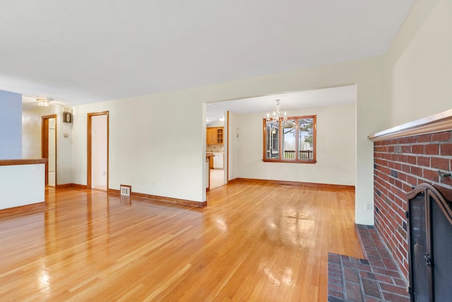 88 Hilltop St, Milton, MA 02186 - unfurnished living room with a chandelier, a fireplace, light wood-type flooring, and baseboards