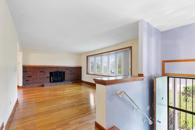 88 Hilltop St, Milton, MA 02186 - unfurnished living room with healthy amount of natural light, light wood finished floors, a fireplace, and baseboards