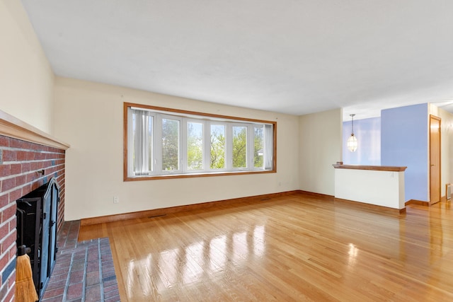 88 Hilltop St, Milton, MA 02186 - unfurnished living room with wood finished floors, a fireplace, and baseboards