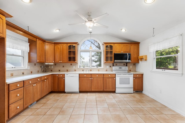 88 Hilltop St, Milton, MA 02186 - kitchen with white appliances, a sink, healthy amount of natural light, vaulted ceiling, and tasteful backsplash