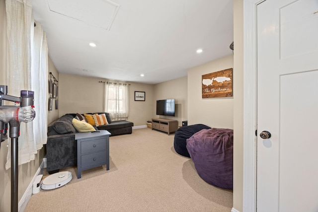 carpeted living area with recessed lighting and baseboards