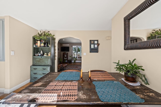 interior space with arched walkways and baseboards