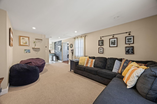 carpeted living area with recessed lighting and baseboards