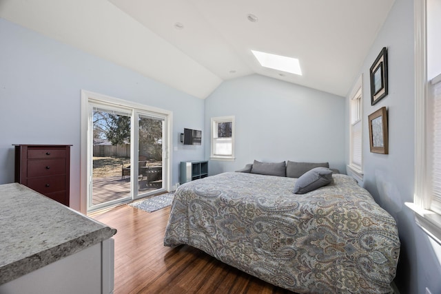 bedroom featuring lofted ceiling with skylight, dark wood finished floors, and access to outside