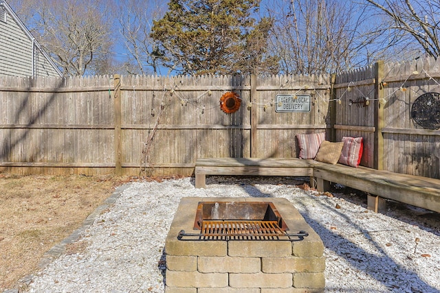 exterior details with fence and an outdoor fire pit