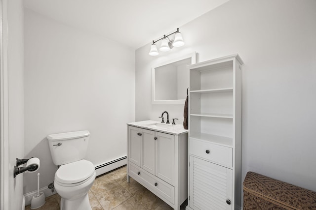 bathroom featuring toilet, vanity, and a baseboard radiator