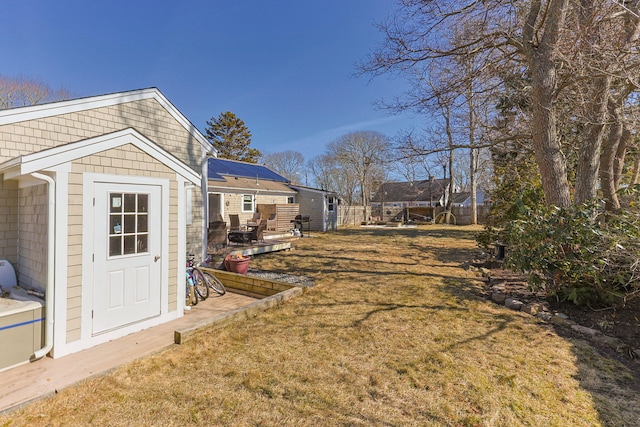 view of yard featuring an outbuilding, a storage unit, and fence