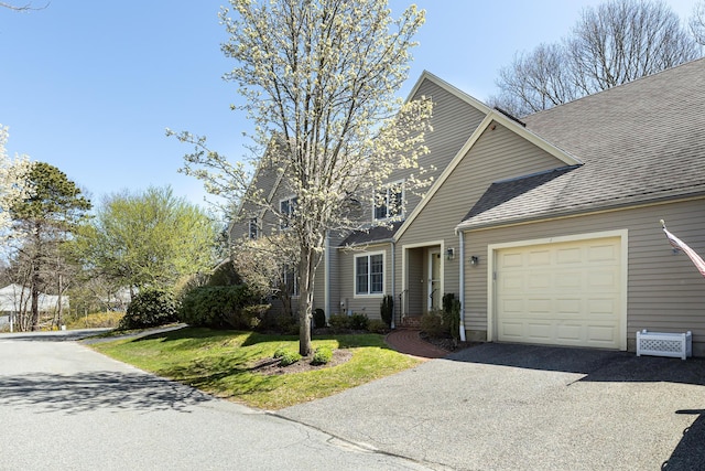 4 Bishops Park, Mashpee, MA 02649 - view of front of home featuring a garage, driveway, a shingled roof, and a front lawn