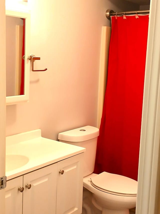 bathroom with vanity, toilet, and walk in shower