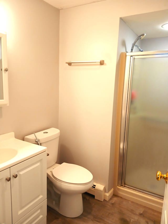 bathroom with a baseboard radiator, an enclosed shower, wood-type flooring, vanity, and toilet