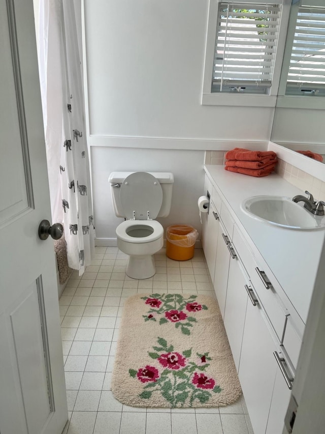 bathroom with vanity, toilet, tile patterned floors, and a shower with curtain