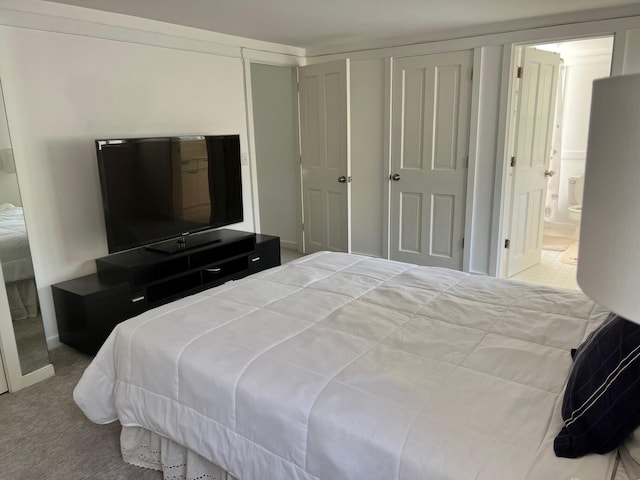 carpeted bedroom featuring connected bathroom