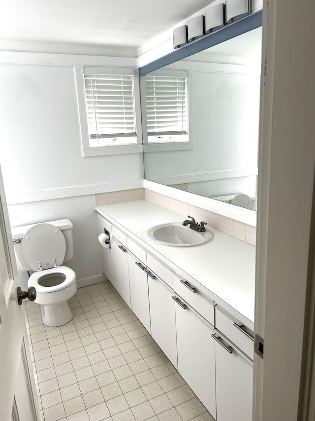 bathroom featuring toilet, tile patterned floors, and vanity