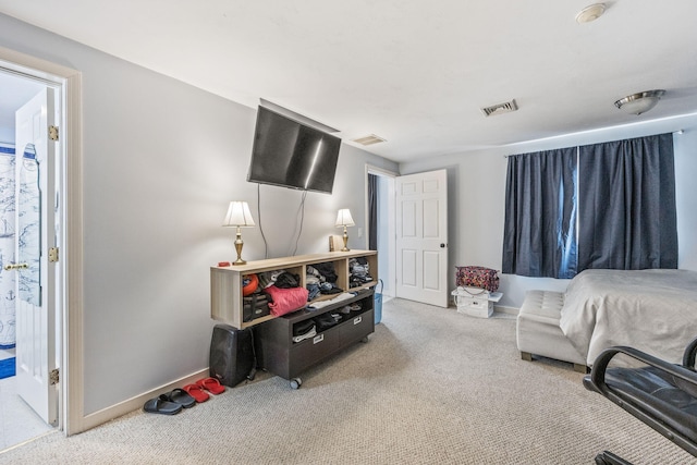 carpeted bedroom featuring visible vents and baseboards