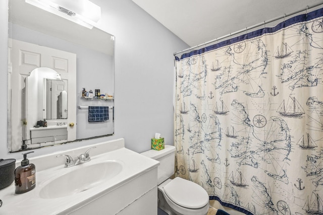 bathroom featuring curtained shower, toilet, and vanity