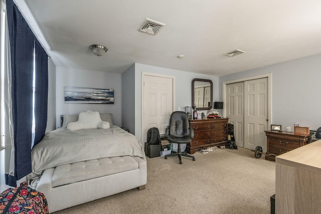 carpeted bedroom featuring visible vents