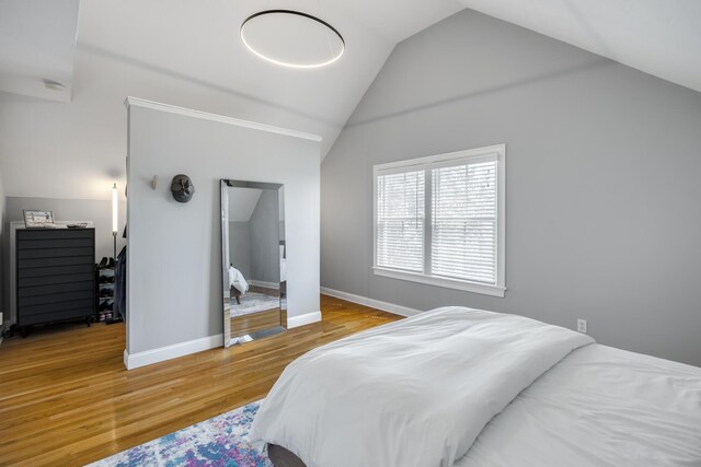 480 Main St Unit 1U, Falmouth, MA 02540 - bedroom featuring baseboards, wood finished floors, and vaulted ceiling