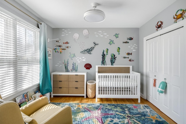 480 Main St Unit 1U, Falmouth, MA 02540 - bedroom featuring a nursery area, a closet, and wood finished floors