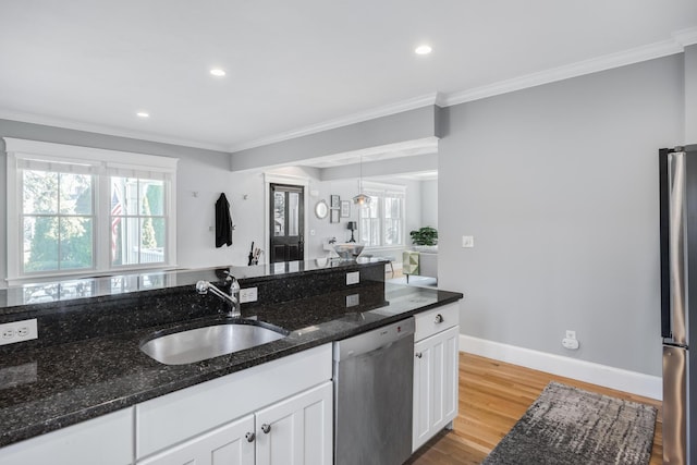 480 Main St Unit 1U, Falmouth, MA 02540 - kitchen featuring light wood finished floors, a sink, crown molding, white cabinetry, and appliances with stainless steel finishes