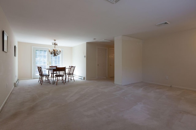 unfurnished dining area with visible vents, light carpet, a baseboard heating unit, baseboards, and a chandelier