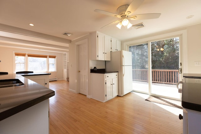 kitchen with visible vents, light wood finished floors, ceiling fan, and freestanding refrigerator