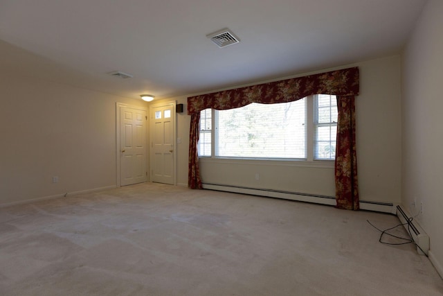 unfurnished room featuring visible vents and light colored carpet