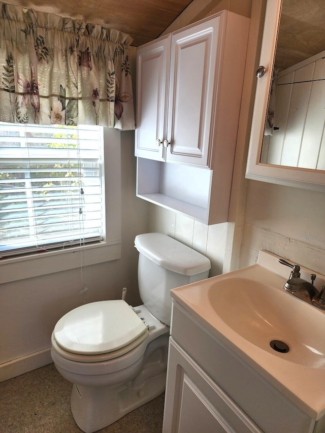 bathroom featuring toilet and vanity