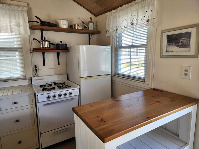 kitchen with white appliances and wooden counters