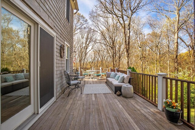 wooden terrace featuring outdoor dining area and an outdoor living space