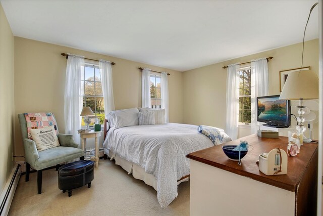 bedroom with a baseboard radiator and carpet