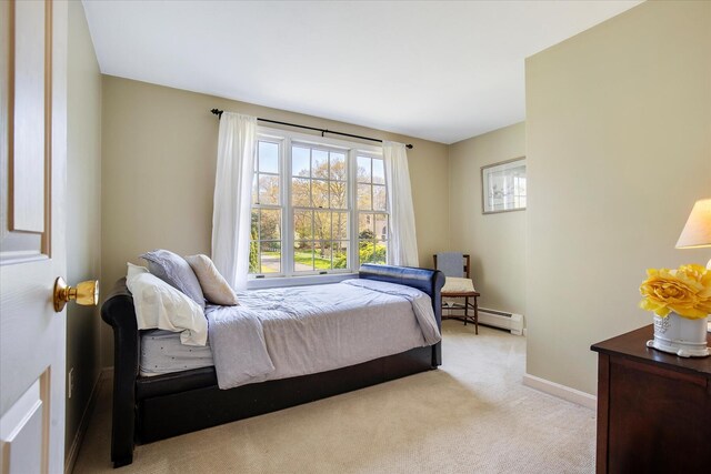 carpeted bedroom with baseboards and a baseboard radiator