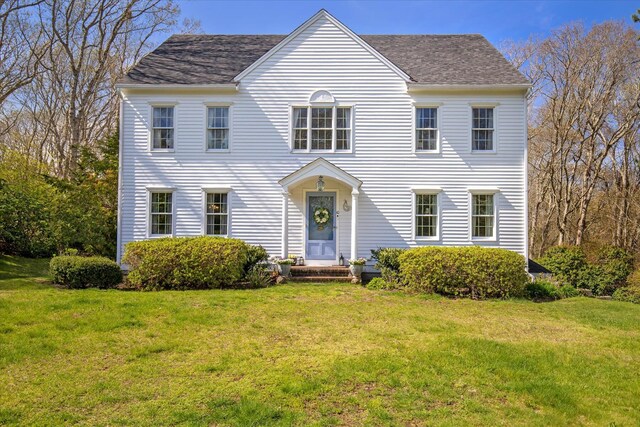 colonial inspired home with a front yard
