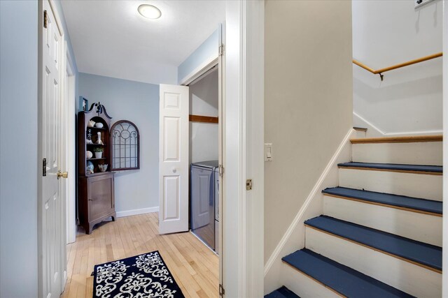staircase with hardwood / wood-style flooring and baseboards