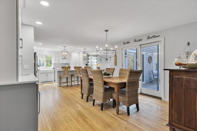 dining room featuring a chandelier, light wood-style flooring, and recessed lighting