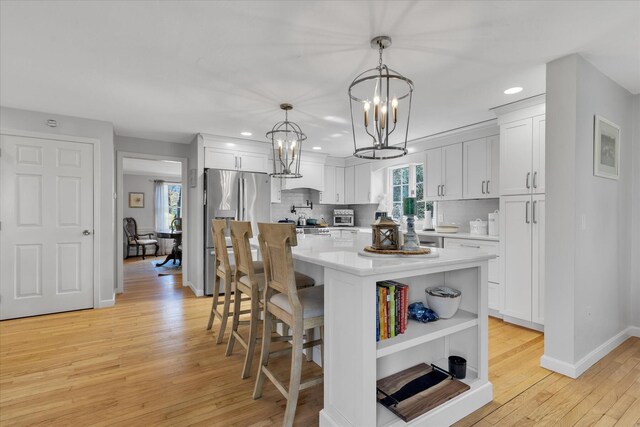 kitchen featuring open shelves, a chandelier, light countertops, backsplash, and recessed lighting