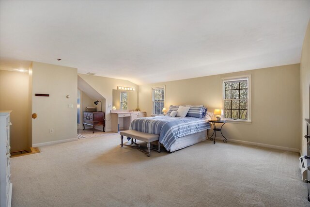 bedroom featuring light carpet, baseboards, and vaulted ceiling