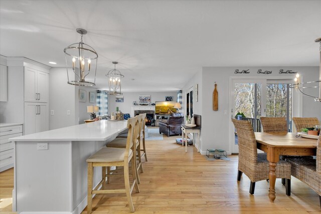 dining space with a chandelier, light wood-style flooring, and recessed lighting
