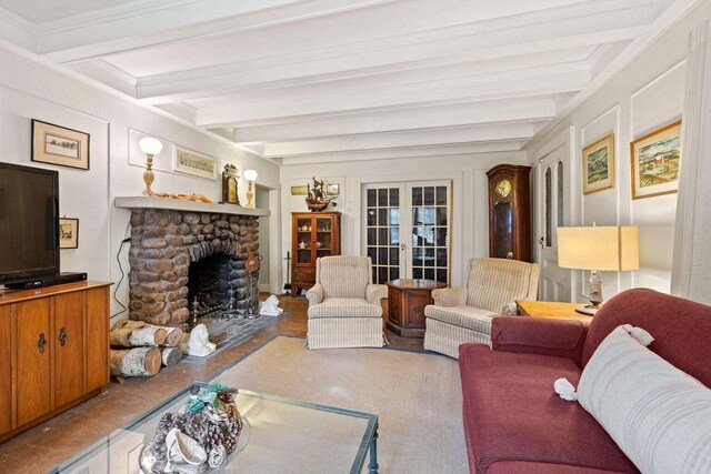 living area with a fireplace, french doors, and beam ceiling