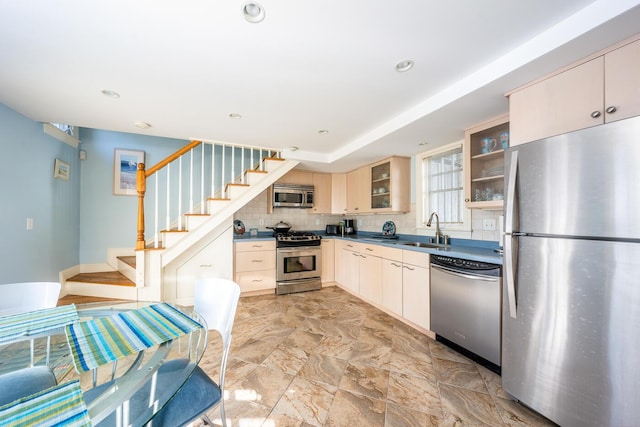 67 Inman Rd Unit X, Dennis Port, MA 02639 - kitchen featuring cream cabinets, appliances with stainless steel finishes, sink, and backsplash