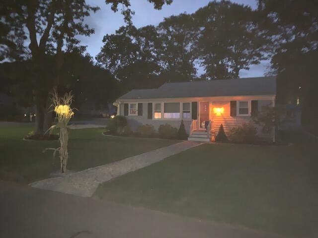 single story home featuring driveway and a front lawn