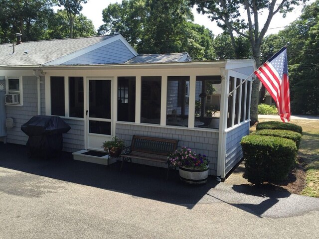 2 Naushon Rd, Mashpee, MA 02649 - rear view of property featuring a sunroom, a shingled roof, and cooling unit