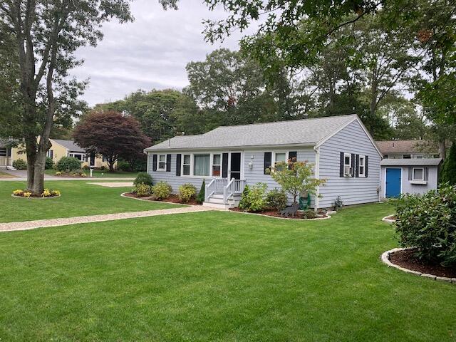 ranch-style house with a front lawn