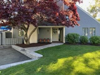 view of front of home with a front lawn and a patio area